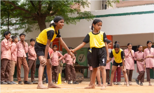 Girls playing a team game at school